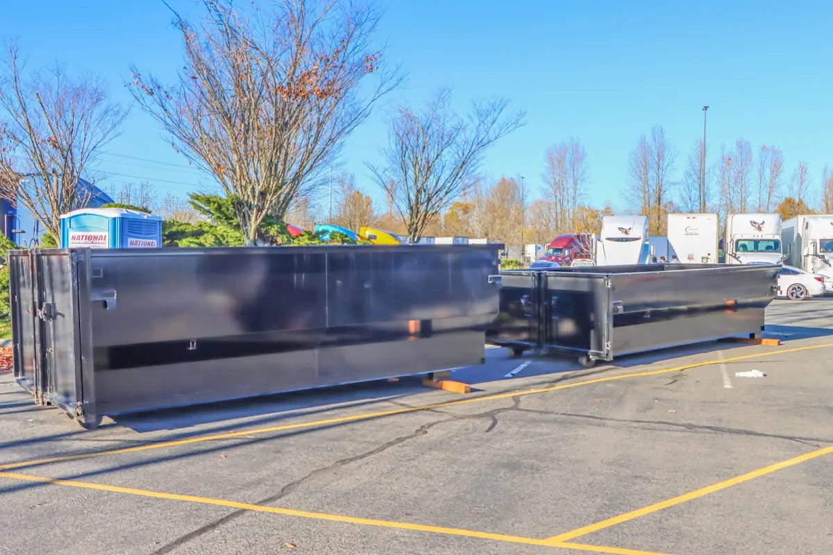 Professional dumpster rental service with roll-off container on residential driveway in Blue Springs